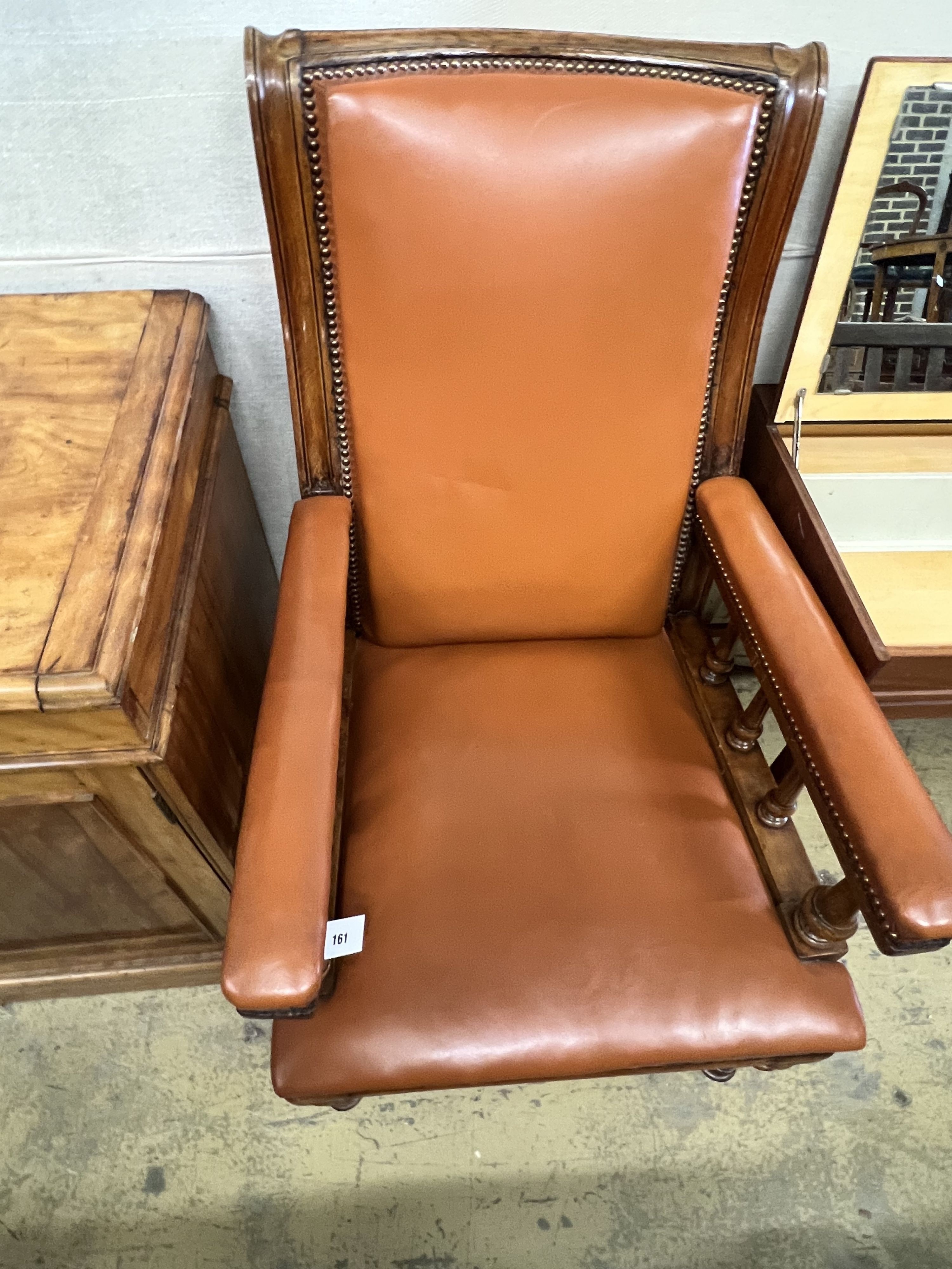 A late Victorian oak and leather library armchair, width 62cm depth 76cm height 110cm